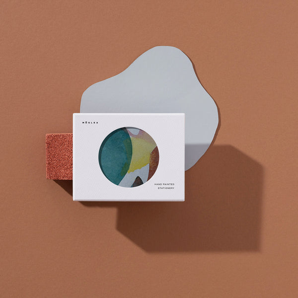 Moglea Moon Stationery Set featuring matching notebooks, pens, and sticky notes with celestial moon design.