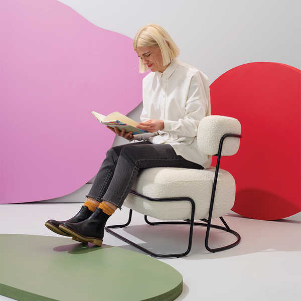 Moglea Francis Chair featuring a sleek, modern design with a wooden frame and cushioned seat and backrest.