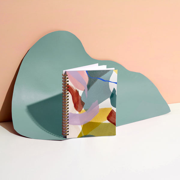 Moglea Calypso Journal notebook with cream cover and gold foil accents, open to show lined pages for writing and note-taking.